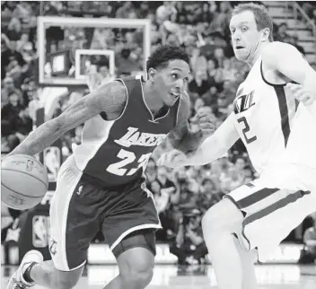  ?? Kim Raff Associated Press ?? LAKERS GUARD Lou Williams drives to the basket against Jazz forward Joe Ingles in the first half. Williams made six of nine shots and scored a team-high 20 points.