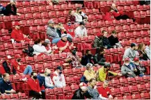  ?? DAVID JABLONSKI / STAFF ?? Reds fans cheer during Tuesday’s game against the Diamondbac­ks at Great American Ball Park. Instead of sitting in groups of six or fewer, fans can soon sit in groups as large as 10.