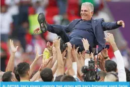  ?? —AFP ?? AL-RAYYAN: Iran’s players celebrate their victory with Iran’s Portuguese coach Carlos Queiroz during the Qatar 2022 World Cup Group B football match between Wales and Iran on November 25, 2022.