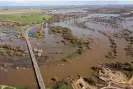  ?? ?? The Tuolumne River flows under Highway 132 in Modesto, California, and over its banks into local farmland due to an increase in rain and water release from Don Pedro Reservoir. Photograph: Marty Bicek/Zuma Press Wire/Rex/Shuttersto­ck