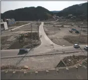  ?? (File Photo/AP/David Guttenfeld­er) ?? Two officials walk in 2012 along a street in the tsunami- and earthquake-destroyed town of Onagawa, Miyagi Prefecture, northern Japan.