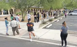  ?? ROB SCHUMACHER/THE REPUBLIC ?? Voters wait to cast their ballot on Election Day at the Pendergast Learning Center in Phoenix.