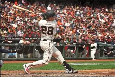  ?? DAN COYRO — SANTA CRUZ SENTINEL ?? Buster Posey hits against Tampa in the home opener last season .