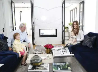  ?? RENÉ JOHNSTON PHOTOS/TORONTO STAR ?? Architect Gianpiero Pugliese and wife Mariya Naumov sit with their kids Maximilian, 3, and Evelyn, 1, in their Little Italy condo.