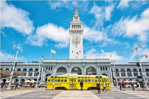  ?? PHOTOS: JUSTIN FRANZ/THE WASHINGTON POST ?? San Francisco’s historic Ferry Building, known for its clock tower, is among the stops on a vintage trolley tour through the city.