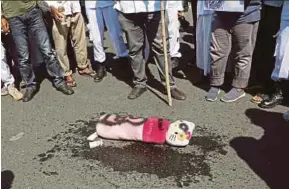  ?? EPA PIC ?? Protesters preparing to burn a Hello Kitty doll during an anti-LGBT rally in Banda Aceh on Friday.