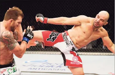  ?? Josh Hedges / Zuffa LLC via Getty Images ?? Glover Teixeira kicks Ryan Bader in their light heavyweigh­t fight during the UFC on Fox Sports 1 event at Mineirinho Arena in Belo Horizonte, Brazil in 2013.