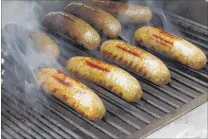  ?? J. MILES CARY / KNOXVILLE NEWS SENTINEL ?? A national abundance of propane means it will cost less to get brats hot during this summer’s grilling season.