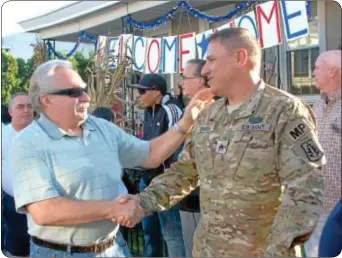  ?? Photograph­s by Jeff Werner ?? Bristol Borough Mayor Robert Lebo welcomes police officer Carlos Rivera home from Afghanista­n.