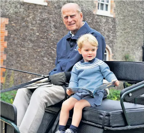  ??  ?? Kensington Palace released this photograph of the Duke of Edinburgh on his carriage with Prince George, as a tribute