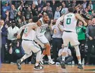  ?? DAVID BUTLER II / USA TODAY SPORTS ?? Boston Celtics forward Marcus Morris celebrates with Shane Larkin and Jayson Tatum after hitting a 3-pointer in the dying seconds to earn his team a 100-99 victory over the Oklahoma City Thunder on Tuesday night in Boston.