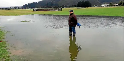  ?? SUPPLIED ?? Wellington Racing Club track manager Kim Treweek surveys the ponding that has caused the cancellati­on of Trentham’s big jumps day on Saturday.