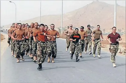  ??  ?? Making history: The NZ Army’s Major Aidan Shattock, right, on a run during a PT session with cadets and other mentors from the Afghan National Army Officer Academy.