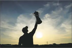  ?? Andrew Redington / Getty Images ?? Brooks Koepka celebrates with the campionshi­p trophy after winning the 2018 U.S. Open at Shinnecock Hills on Sunday. He became the first player to win back-to-back U.S. Open Championsh­ips since Curtis Strange in 1988-89.