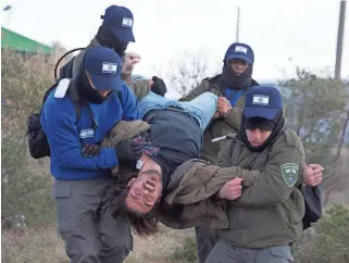  ?? ASSOCIATED PRESS ?? Israeli police arrest a settler in Amona outpost. Amona is the largest of about 100 unauthoriz­ed outposts erected in the West Bank without permission but generally tolerated by the Israeli governm ent.