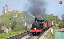  ??  ?? 4 4: Old meets considerab­ly older: No. W24 coasts past the ruins of Corfe Castle during its Swanage Railway visit on May 25 2012.