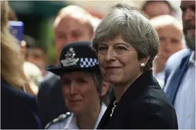  ?? (Niklas Hallen/Reuters) ?? BRITISH PRIME MINISTER Theresa May meets market traders with Australian Prime Minister Malcolm Turnbull during a visit to Borough Market in London yesterday.