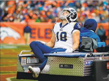  ?? Justin Edmonds Getty Images ?? COOPER KUPP is carted off the field at Denver with a sprained knee that will keep him out of Sunday’s game at San Francisco. If Kupp’s injury lingers, the Rams could add another receiver, coach Sean McVay said.