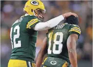  ?? RICK WOOD / MILWAUKEE JOURNAL SENTINEL ?? Packers quarterbac­k Aaron Rodgers congratula­tes wide receiver Randall Cobb after a second-half touchdown Sunday.
