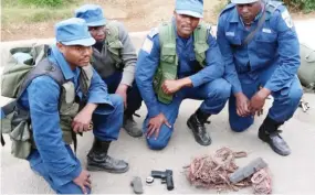  ?? ?? National security border control team displays a pistol recovered together with 13kg of copper cables after being dropped by a suspected armed robber at Nyampanzan­i along the Limpopo River on Monday afternoon. The armed robber escaped to South Africa and is believed to be part of the many criminals along the border