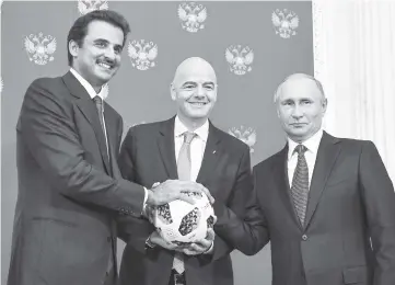  ??  ?? Amir of Qatar Sheikh Tamim bin Hamad Al-Thani (left), FIFA president Gianni Infantino (centre) and Russia President Vladimir Putin pose for a photograph­y during a symbolic transfer of the authority to Qatar to host the World Cup 2022 at the Kremlin in...