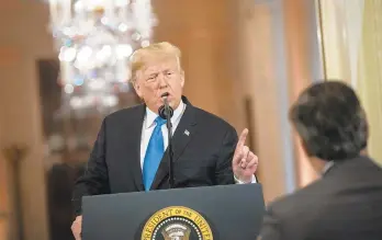  ?? AL DRAGO/POOL PHOTO VIA GETTY IMAGES ?? President Donald Trump gets into an exchange with CNN reporter Jim Acosta during a news conference Nov. 7, a day after the midterm elections. Trump later revoked Acosta’s White House press credential­s, but a judge reinstated them.