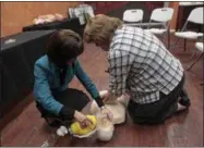  ?? KATHY WILLENS — THE ASSOCIATED PRESS, FILE ?? Yochevev Lerner, right, demonstrat­es cardiopulm­onary resuscitat­ion technique to attorney Rachel Freier during a women’s-only CPR training session in the Borough Park section of New York.