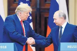  ?? JUSSI NUKARI/LEHTIKUVA ?? U.S. President Donald Trump and Russian President Vladimir Putin shake hands during a join press conference at the Presidenti­al Palace in Helsinki, Finland, on Monday.