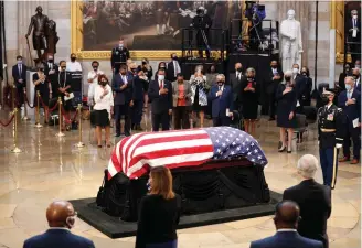  ?? Shawn They/AP, Pool ?? ■ House Speaker Nancy Pelosi of California, second from left, attends a memorial service for Rep. John Lewis, D-Ga., whose flag-draped casket lies in state Monday at the Capitol Rotunda in Washington.
