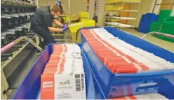  ?? AP PHOTO/TED S. WARREN ?? Vote-by-mail ballots are shown in sorting trays Wednesday at the King County Elections headquarte­rs in Renton, Wash. Never in U.S. history will so many people exercise the right on which their democracy hinges by marking a ballot at home.