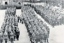  ?? ?? Supposedly inescapabl­e: Colditz today, top; prisoners during the war lining up to be counted, left