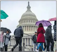  ??  ?? AP/J. SCOTT APPLEWHITE Rain greets tourists Friday morning at the U.S. Capitol. Congressio­nal leaders have left Washington, but aides said they could return if an agreement to end the government shutdown is reached.