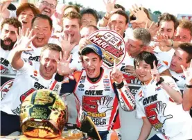  ??  ?? Spain’s Marc Marquez, centre, celebrates with team staff after winning the MotoGP of Japan Photo: AP