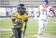  ?? [PHOTO BY EVAN BROWN, FOR THE TULSA WORLD] ?? Midwest City’s Brian Wilson breaks a run for a big gain against the Bixby defense in Friday’s playoff game at Jenks High School.