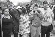  ?? AARON LAVINSKY/STAR TRIBUNE VIA AP ?? Family and friends of Daunte Wright, 20, grieve at 63rd Avenue North and Lee Avenue North hours after they say he was shot and killed by police Sunday in Brooklyn Center, Minn. Wright’s mother, Katie Wright, stands at center.