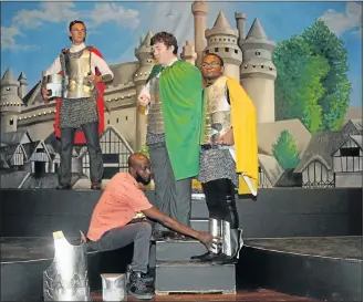  ?? Picture: FREDLIN ADRIAAN ?? KITTED OUT: Amos Mpofu, front, adjusting the armour of Sibongile Ponase, 17, right. Also taking part in the play are ‘Camelot’ actors Daniel Schink, 16, left, and Ronan de Klerk, 15