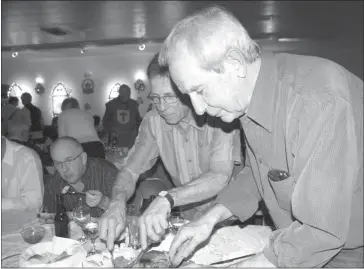  ?? PHOTOS BY CLAUDIA VILLEMAIRE ?? Confrontin­g a large platter of a variety of roasted meats took concentrat­ion for would-be carvers. But sharp knives and forks, (unheard of in that time period) were supplied and the delicious variety of duck, chicken, quail and pork was soon enjoyed along with a variety of vegetables representi­ng the life and times during the Middle Ages on the Emerald Isle.