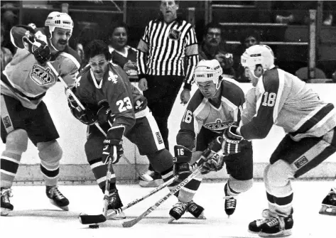  ?? ALVIN CHUNG/THE CANADIAN PRESS FILES ?? Jacques Richard of the Quebec Nordiques is surrounded by Los Angeles Kings Charlie Simmer, from left, Marcel Dionne and Dave Taylor as they scramble for possession of the puck at the Los Angeles Forum in March 1983. Sometimes when three players click...