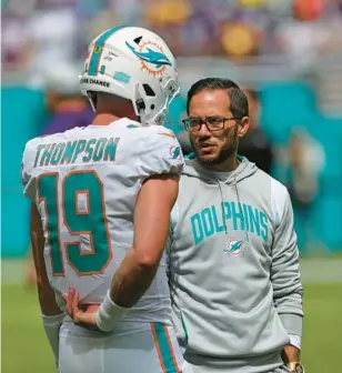  ?? JOHN MCCALL/SOUTH FLORIDA SUN SENTINEL ?? Dolphins coach Mike McDaniel and rookie quarterbac­k Skylar Thompson are an unlikely playoff tandem as they go to Buffalo on Sunday.