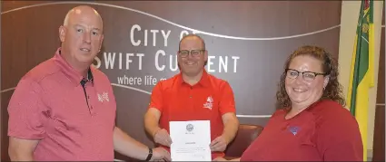  ??  ?? Games co-chairs Mark Benesh and Melissa Shaw assisted Mayor Denis Perrault in proclaimin­g Aguust 9 to 18 as 2019 Western Canada Summer Games Week in Swift Current.