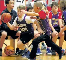  ?? CLIFFORD SKARSTEDT/EXAMINER ?? Westmount's Cameron Donato pressures James Strath's Cooper Mann during the Kawartha Pine Ridge Elementary Athletic Associatio­n North junior elementary boys basketball tournament on Wednesday at Crestwood Secondary School. Westmount lost 36-24 against...