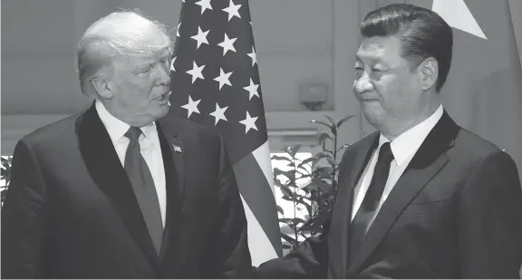  ?? SAUL LOEB / THE ASSOCIATED PRESS FILE PHOTO ?? U.S. President Donald Trump, left, and China’s President Xi Jinping at a meeting on the sidelines of the G-20 Summit in Hamburg, Germany, last summer. There’s little doubt the tax on anything Chinese would inflate prices for U.S. consumers and make...