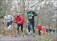  ??  ?? Runners battle their way up a steep incline