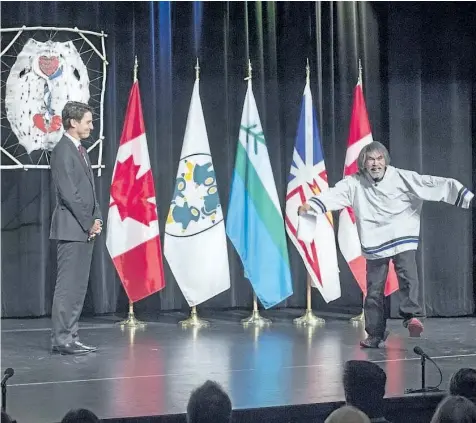  ?? ANDREW VAUGHAN/THE CANADIAN PRESS ?? Prime Minister Justin Trudeau welcomes residentia­l survivor Toby Obed to the stage after delivering an apology on behalf of the Government of Canada to former students of the Newfoundla­nd and Labrador Residentia­l Schools in Happy Valley-Goose Bay,...