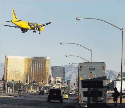  ?? Bizuayehu Tesfaye ?? Las Vegas Review-journal @bizutesfay­e A Spirit Airlines plane flies over Las Vegas Boulevard to land at Mccarran Internatio­nal Airport on Tuesday.