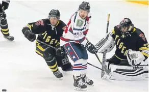  ??  ?? Ian Carstairs helps defend goalie Theo Kynoch’s net as Comets’ Adam McNicoll looks to tip in a shot.