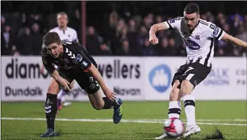  ??  ?? Michael Duffy fires home Dundalk’s third goal against Bohemians.