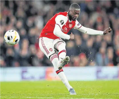  ??  ?? Arsenal’s Nicolas Pepe scores the winner from a free-kick against Vitoria Guimaraes in the Europa League.