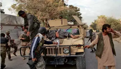  ?? AP ?? AWOUNDED civilian lies on the hood of a Humvee en route to a hospital in Kunduz City. Three staff members of Doctors Without Borders were killed and 30 were reported missing after the charity group’s hospital in Kunduz was apparently hit in a US air...