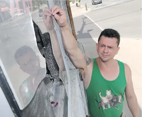  ??  ?? Sam Fallon, owner of Sam’s Pampered Pets in Belle River, shows the storefront window that was smashed early Sunday during an altercatio­n between people in front of his business. Fallon believes the incidence of vandalism and the conflict that led to it...